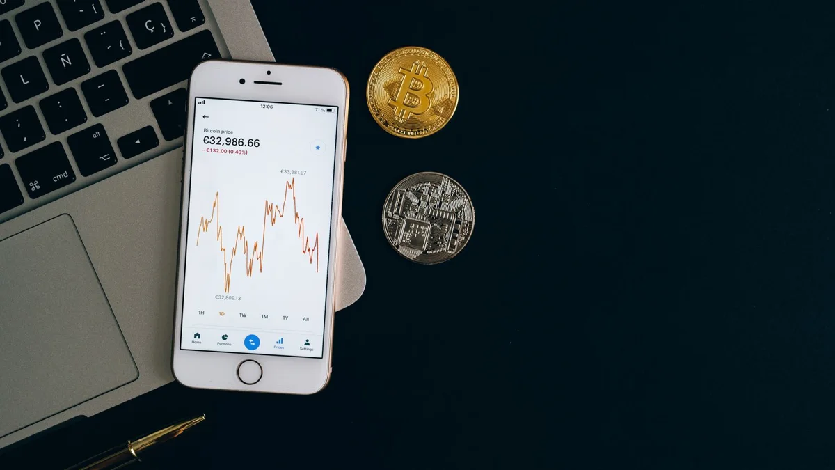 How to launch a token on BSC: price chart on a phone next to coins in the first trading days